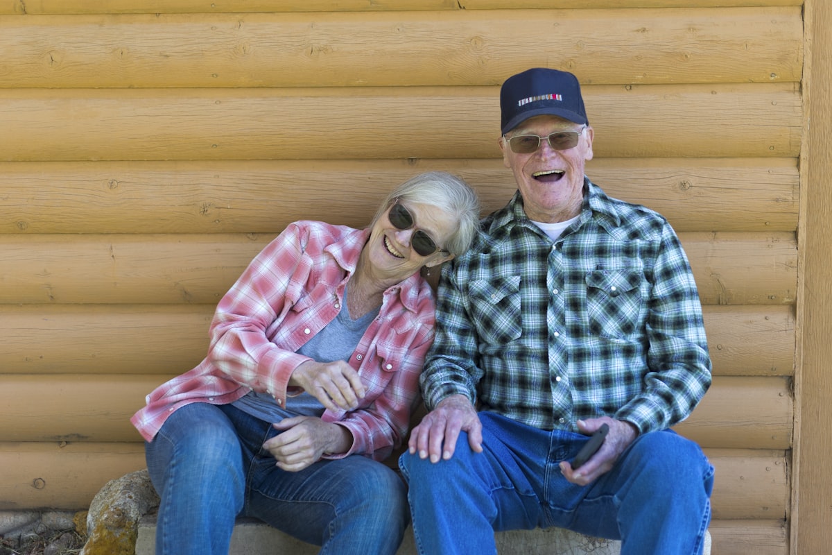 An older couple sitting together outdoors, representing healthy aging
